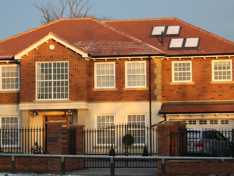 Home with hot water system powered by solar panels on the roof